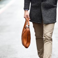 fashionable man's legs with a leather bag on the street - fashion stock pictures, royalty-free photos & images