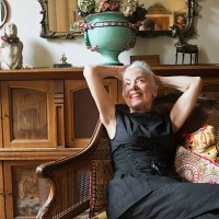 fashionable woman resting on antique chair smiling - home decoration stock pictures, royalty-free photos & images