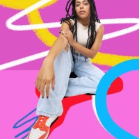 fashionable woman sitting against colourful background - fashion stock pictures, royalty-free photos & images