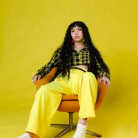 fashionable woman standing against plain background - fashion stock pictures, royalty-free photos & images