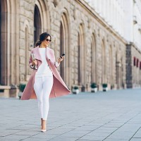 fashionable woman texting outdoors - fashion stock pictures, royalty-free photos & images