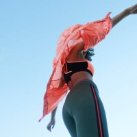 fashionable woman wearing jacket with sports clothing against clear sky - fashion stock pictures, royalty-free photos & images