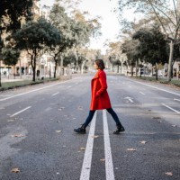 fashionable woman wearing winter jacket walking on road - fashion photos et images de collection