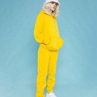 fashionable woman wearing yellow track suit - fashion stock pictures, royalty-free photos & images