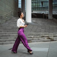 fashionable young businesswoman walking while holding diary in city - fashion stock pictures, royalty-free photos & images