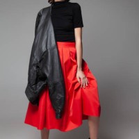fashionable young woman standing with black jacket in studio - fashion stock pictures, royalty-free photos & images