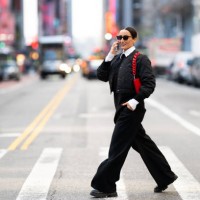 fashionably dressed female business person seen on the street of new york talking on the phone and smiling - fashion stock pictures, royalty-free photos & images