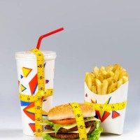 fast food meal with tape measure - junk food stock pictures, royalty-free photos & images