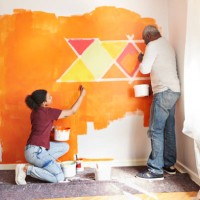 father and daughter painting wall at home - home decoration stock pictures, royalty-free photos & images