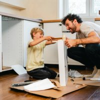 father and son assembling kitchen furniture - home decoration stock pictures, royalty-free photos & images