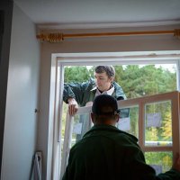 father and son builders installing new window in house - home decoration stock pictures, royalty-free photos & images