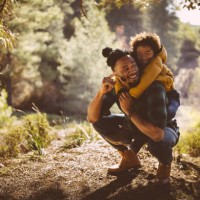 father and son having fun with piggyback ride in forest - travel stock pictures, royalty-free photos & images