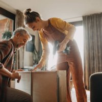 father and teen daughter assembling new furniture in the renovated apartment - home decoration stock pictures, royalty-free photos & images