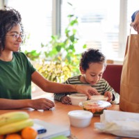 father having take away food with his children at home. - junk food stock pictures, royalty-free photos & images