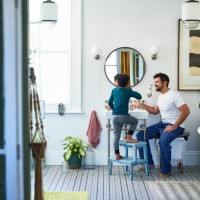father helping son brushing teeth in bathroom - home decoration stock pictures, royalty-free photos & images