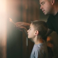 father helping son paint - home decoration stock pictures, royalty-free photos & images