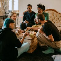 female and male friends having breakfast in living room at home - food stock pictures, royalty-free photos & images
