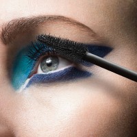 female applying mascara, close up - fashion stock-fotos und bilder