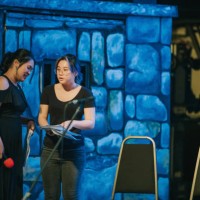 female asian chinese producer and emcee discussion on stage before the concert opening - concert stock pictures, royalty-free photos & images