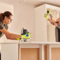 female carpenter routing kitchen counter - home decoration stock pictures, royalty-free photos & images
