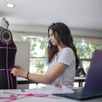 female college fashion student attending class in the classroom working on their fashion design - fashion stock pictures, royalty-free photos & images