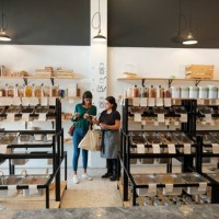 female costumer and shop assitant looking at products in store - home decoration stock pictures, royalty-free photos & images