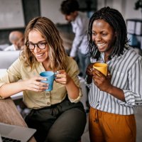 female coworkers looking at laptop and laughing - coffee stock pictures, royalty-free photos & images