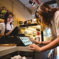 female customer buying food on digital tablet at cashier counter - food stock pictures, royalty-free photos & images