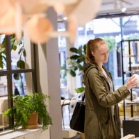 female customer looking at object while standing in store - home decoration stock pictures, royalty-free photos & images
