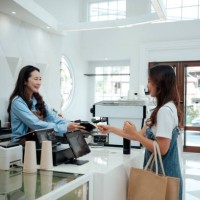 female customer using credit card contactless payment at café - junk food stock pictures, royalty-free photos & images