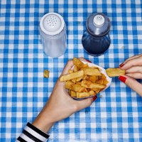 female eating chips with salt and vinegar - junk food stock pictures, royalty-free photos & images