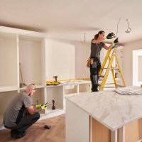 female electrician working in a kitchen remodelling - home decoration stock pictures, royalty-free photos & images
