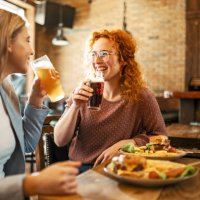 female friends having a beer - junk food stock pictures, royalty-free photos & images
