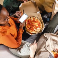 female friends ordering food online - junk food stock pictures, royalty-free photos & images