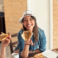 female friends sharing a pizza - junk food stock pictures, royalty-free photos & images