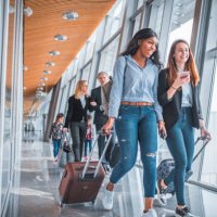 female friends walking by window at airport - travel stock pictures, royalty-free photos & images