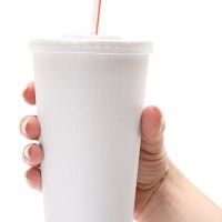 female hand holds white disposable cup - junk food stock pictures, royalty-free photos & images