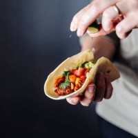 female hand squeezing lime into vegan tacos - food stock pictures, royalty-free photos & images