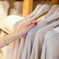 female hand taking a clothes out at clothing store - fashion stock pictures, royalty-free photos & images