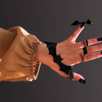 female hand with black manicure and decor in the shape of a bat. halloween theme. - nails art photos et images de collection
