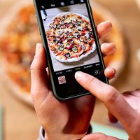 female hand with cell phone taking pictures of pizza - junk food stock pictures, royalty-free photos & images