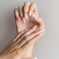 female hand with long nail polish manicure in beige glossy color. - nails art stock pictures, royalty-free photos & images