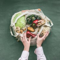 female hands holding eco friendly mesh shopping bag with vegetables - food stock pictures, royalty-free photos & images