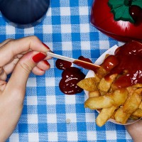 female holding chips with ketchup, messy - junk food stock pictures, royalty-free photos & images