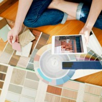 female interior designer using a tablet while looking over swatches at work - home decoration stock pictures, royalty-free photos & images