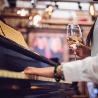female piano player playing and drinking wine at a restaurant - concert stock pictures, royalty-free photos & images