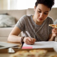 female student studying and listening to music at home - junk food stock pictures, royalty-free photos & images