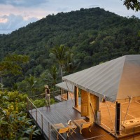 female tourist admiring sea view while standing on decking of tented villa, at eco friendly luxury glamping resort, at dawn - travel stock pictures, royalty-free photos & images