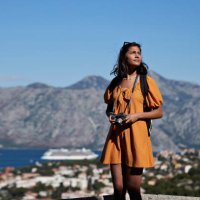 female tourist with camera against mountain range - travel stock pictures, royalty-free photos & images