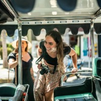 female traveler friends entering a local taxi - travel stock pictures, royalty-free photos & images